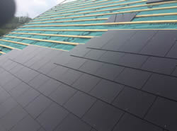 New slates being laid on roof repair
